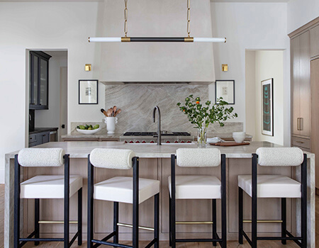 Carrara marble kitchen with luxury range and custom pot holder detail in Houston, TX